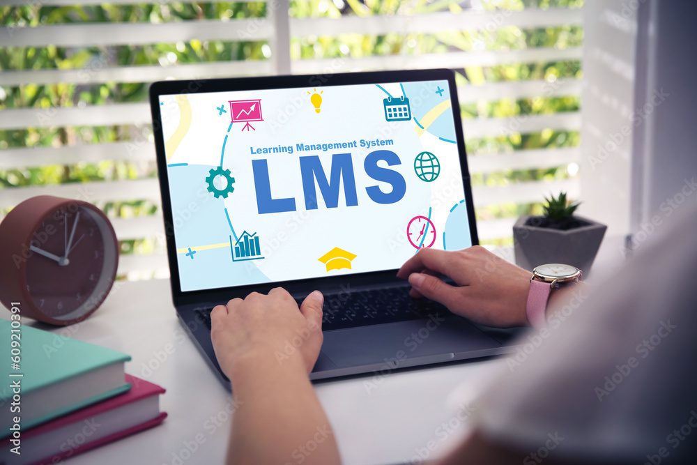 Learning management system. Woman working with modern laptop at table, closeup. Different icons and abbreviation LMS on screen